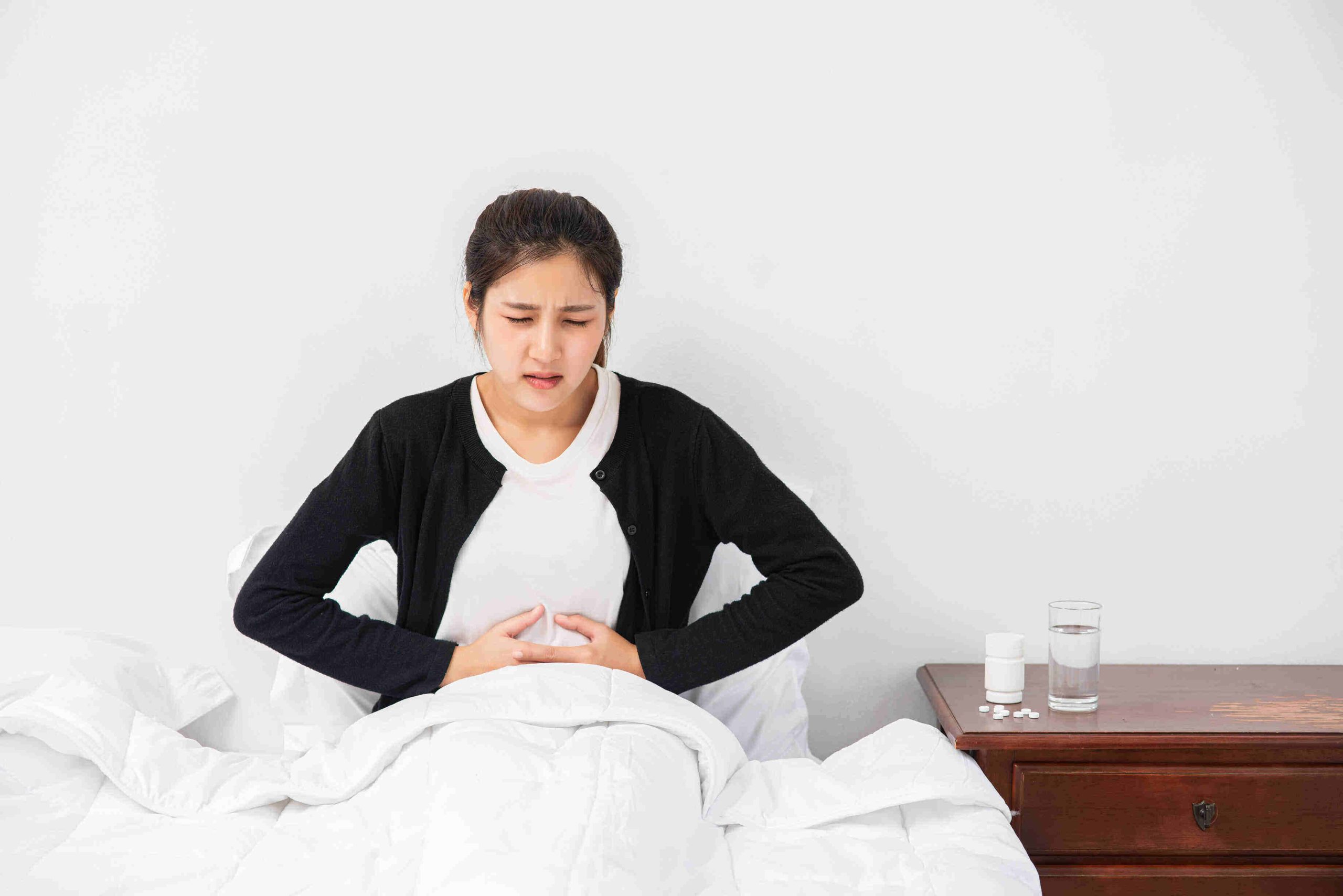 Abdominal pain pressing her hand and her stomach