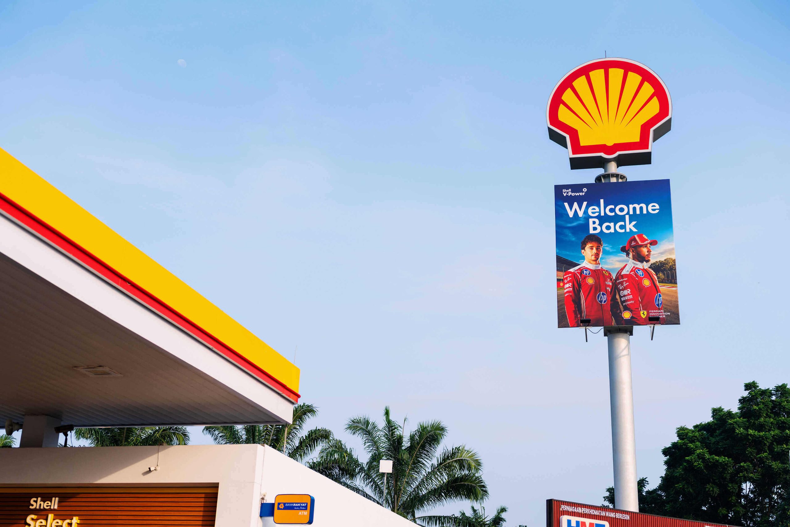 A welcome billboard at a retail station during the Shell Malaysia race weekend featuring Scuderia Ferrari HP drivers